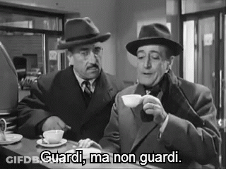 Two Men Are Sitting At A Counter Drinking Coffee And One Of Them Is Saying `` Guardi , Ma Non Guardi '' . GIF