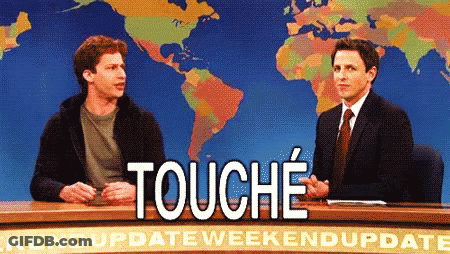 Two Men Are Sitting At A Desk With A Sign That Says " Touche " GIF