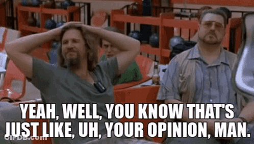 Two Men Are Sitting At A Table In A Bowling Alley With Their Hands On Their Head . GIF