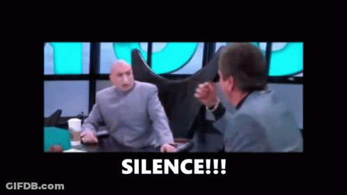 Two Men Are Sitting At A Table Talking To Each Other And The Words `` Silence '' Are Visible In The Corner . GIF
