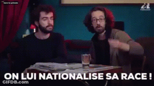 Two Men Are Sitting At A Table With A Glass Of Beer And A Stack Of Papers . GIF