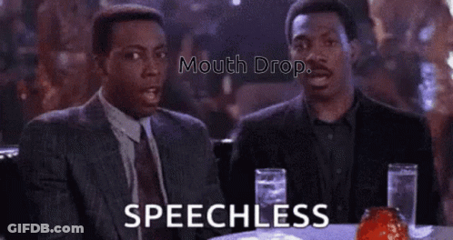 Two Men Are Sitting At A Table With Glasses Of Water And Talking . GIF