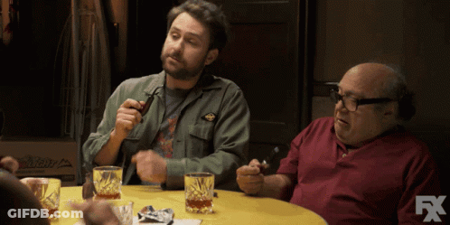 Two Men Are Sitting At A Table With Glasses Of Whiskey And A Fx Logo In The Corner GIF