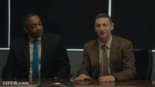 Two Men Are Sitting At A Table With The Name Coward On The Screen GIF