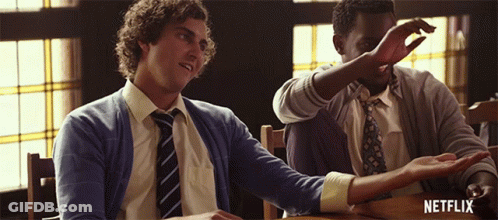 Two Men Are Sitting At A Table With The Word Netflix On The Bottom GIF