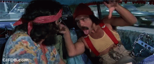 Two Men Are Sitting In A Car And One Is Sticking His Tongue Out . GIF