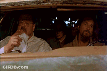 Two Men Are Sitting In A Car One Is Smoking A Cigarette GIF