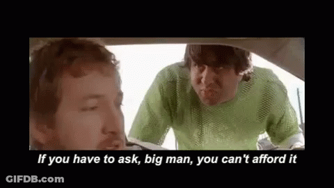 Two Men Are Sitting In A Car Talking To Each Other . GIF
