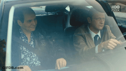 Two Men Are Sitting In A Car With Hbo Max On The Bottom Right GIF