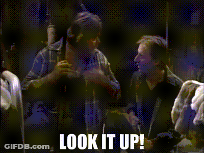 Two Men Are Sitting In A Dark Room With The Words Look It Up Written On The Bottom GIF