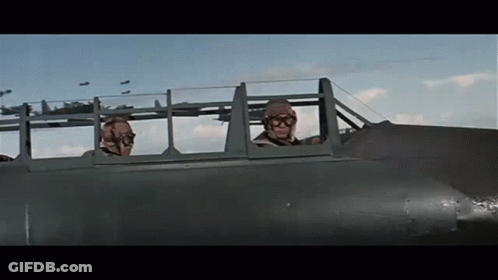 Two Men Are Sitting In A Plane Looking Out The Windows GIF