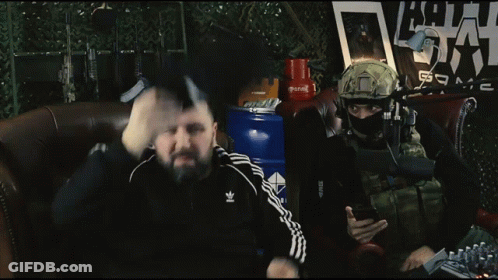 Two Men Are Sitting In Front Of A Microphone With A Sign Behind Them That Says ' Army ' GIF