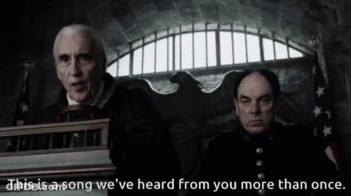 Two Men Are Sitting In Front Of A Podium With The Words " This Is A Song We 'Ve Heard From You More Than Once " GIF