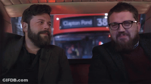 Two Men Sitting In Front Of Red Clinton Pond Bus GIF