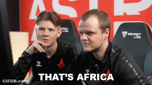 Two Men Are Sitting In Front Of A Sign That Says Secret Lab GIF