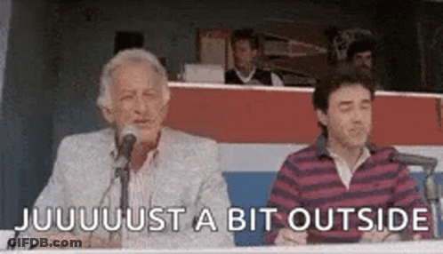 Two Men Are Sitting In Front Of Microphones And One Of Them Is Talking . GIF