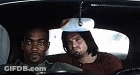 Two Men Are Sitting In The Back Seat Of A Car And Looking At The Rear View Mirror . GIF