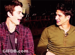 Two Men Are Sitting Next To Each Other And Laughing Together GIF