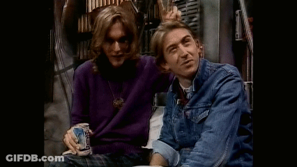 Two Men Are Sitting Next To Each Other And One Is Holding A Beer Can . GIF