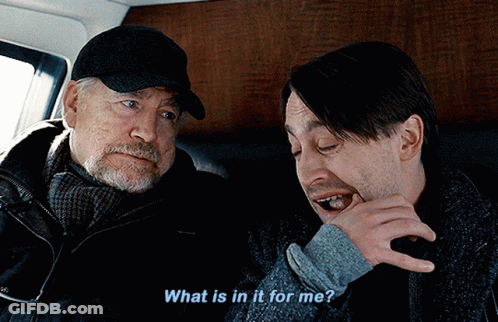 Two Men Are Sitting Next To Each Other And One Of Them Is Asking The Other What Is In It For Me GIF