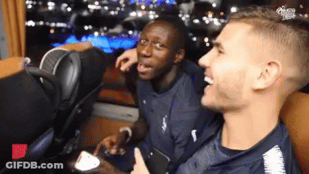 Two Men Are Sitting Next To Each Other And One Of Them Is Giving A Thumbs Up Sign GIF