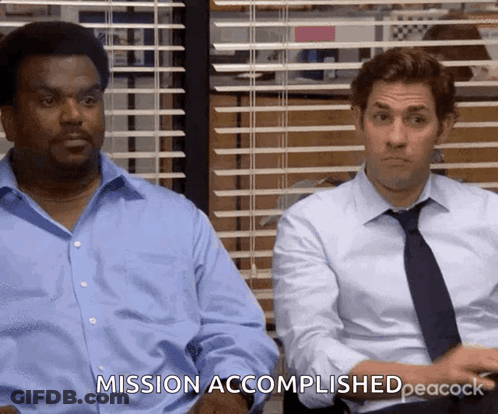 Two Men Are Sitting Next To Each Other And One Of Them Is Saying Mission Accomplished Peacock GIF