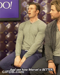 Two Men Are Sitting Next To Each Other And One Of Them Says And See How Marvel Is Better GIF