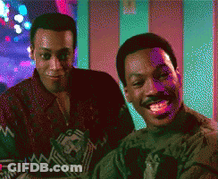 Two Men Are Sitting Next To Each Other And Smiling In A Pixelated Image GIF