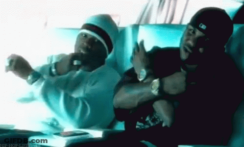 Two Men Are Sitting Next To Each Other In A Car And One Is Wearing A Hat That Says MLB On It GIF