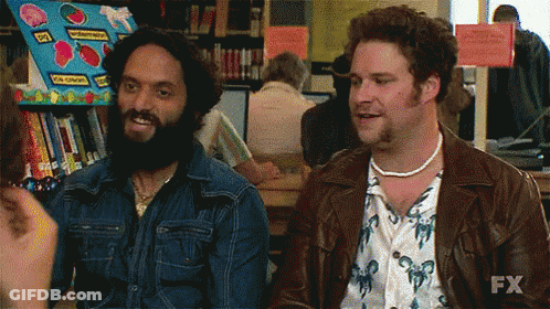 Two Men Are Sitting Next To Each Other In A Library And One Of Them Is Saying Nailed It GIF