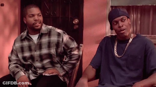 Two Men Are Sitting Next To Each Other In Front Of A Door And Talking GIF