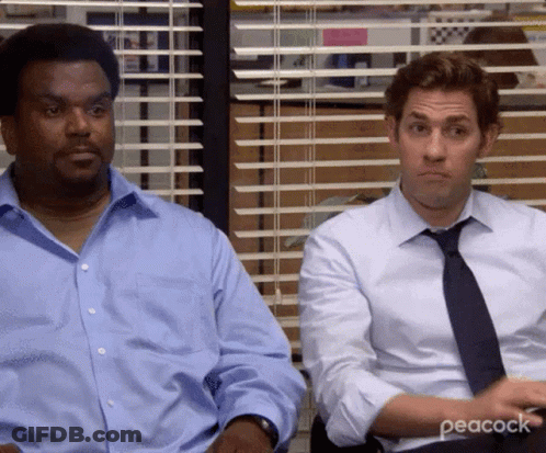 Two Men Are Sitting Next To Each Other In Front Of A Window In An Office . GIF