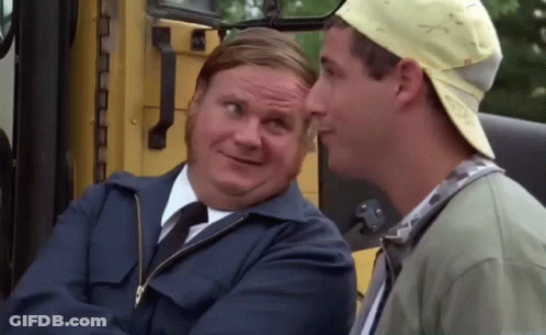 Two Men Are Sitting Next To Each Other In Front Of A Yellow Bus And Talking To Each Other . GIF