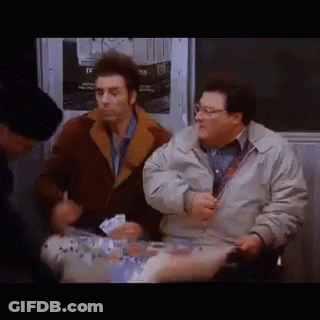 Two Men Are Sitting Next To Each Other On A Subway And Talking . GIF