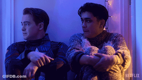 Two Men Are Sitting Next To Each Other With A Netflix Logo In The Background GIF
