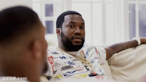 Two Men Are Sitting On A Couch And One Of Them Is Wearing A Shirt That Says " Freedom " GIF