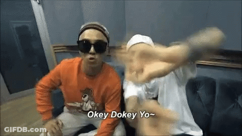 Two Men Are Sitting On A Couch And One Of Them Is Wearing Sunglasses And An Orange Shirt . GIF