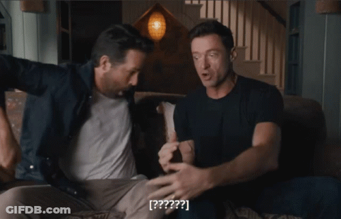 Two Men Are Sitting On A Couch And One Of Them Says [ ? ] On The Screen GIF