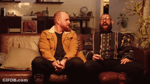 Two Men Sitting On Couch Laughing GIF