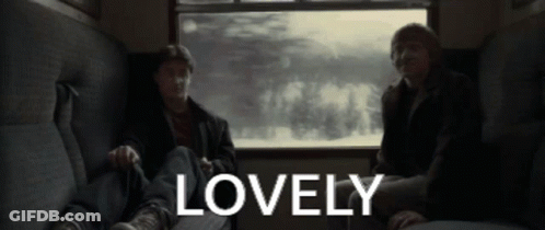 Two Men Are Sitting On A Couch With The Word Lovely In The Corner GIF