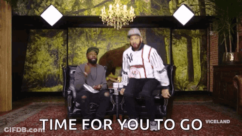 Two Men Are Sitting On A Couch With The Words Time For You To Go GIF