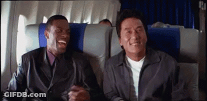 Two Men Are Sitting On A Plane Laughing . GIF