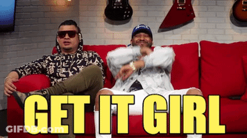 Two Men Are Sitting On A Red Couch With The Words Get It Girl Written In Yellow GIF