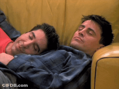 Two Men Are Sleeping On A Yellow Couch GIF