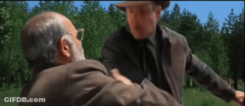 Two Men Are Standing In A Field And One Has A Beard GIF