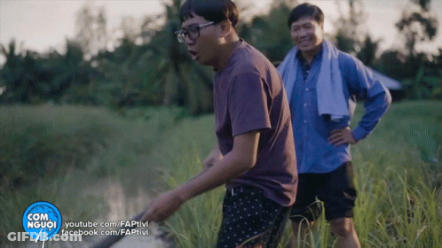 Two Men Are Standing In A Field With A Youtube.com Logo In The Corner GIF