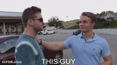 Two Men Are Standing In A Parking Lot And The Word This Guy Is On The Bottom Right GIF
