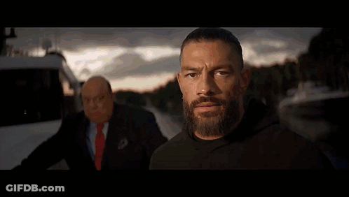 Two Men Are Standing In A Wrestling Ring And One Has A Shirt That Says Tribal Chief On It GIF