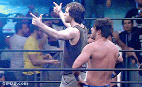 Two Men Are Standing In A Wrestling Ring And One Is Pointing GIF