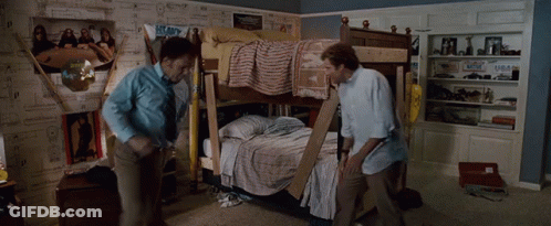 Two Men Are Standing In Front Of A Bunk Bed In A Room GIF